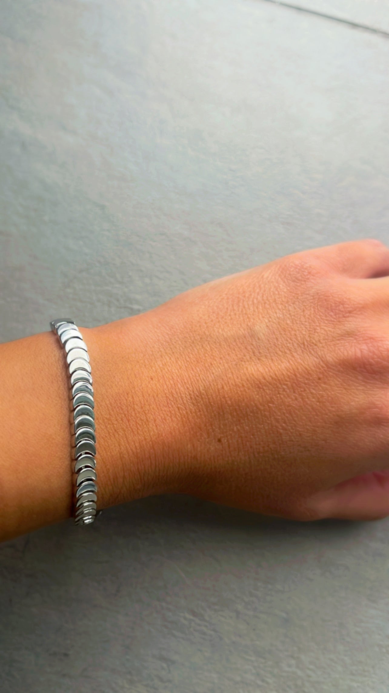 Silver bangle with a tennis bracelet clasp
