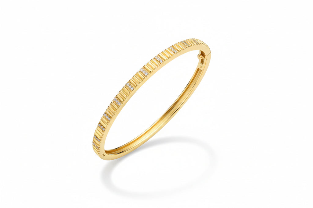 Gold bracelet with small diamonds on a white background