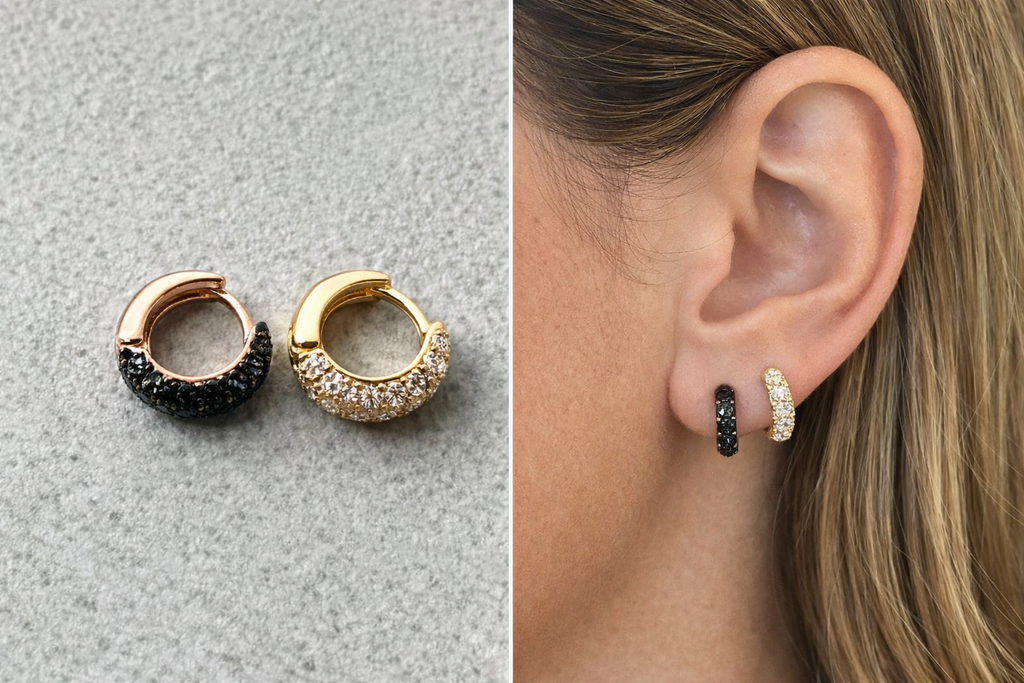 Pair of hoop earrings with black and gold accents on a gray surface, shown worn on an ear.