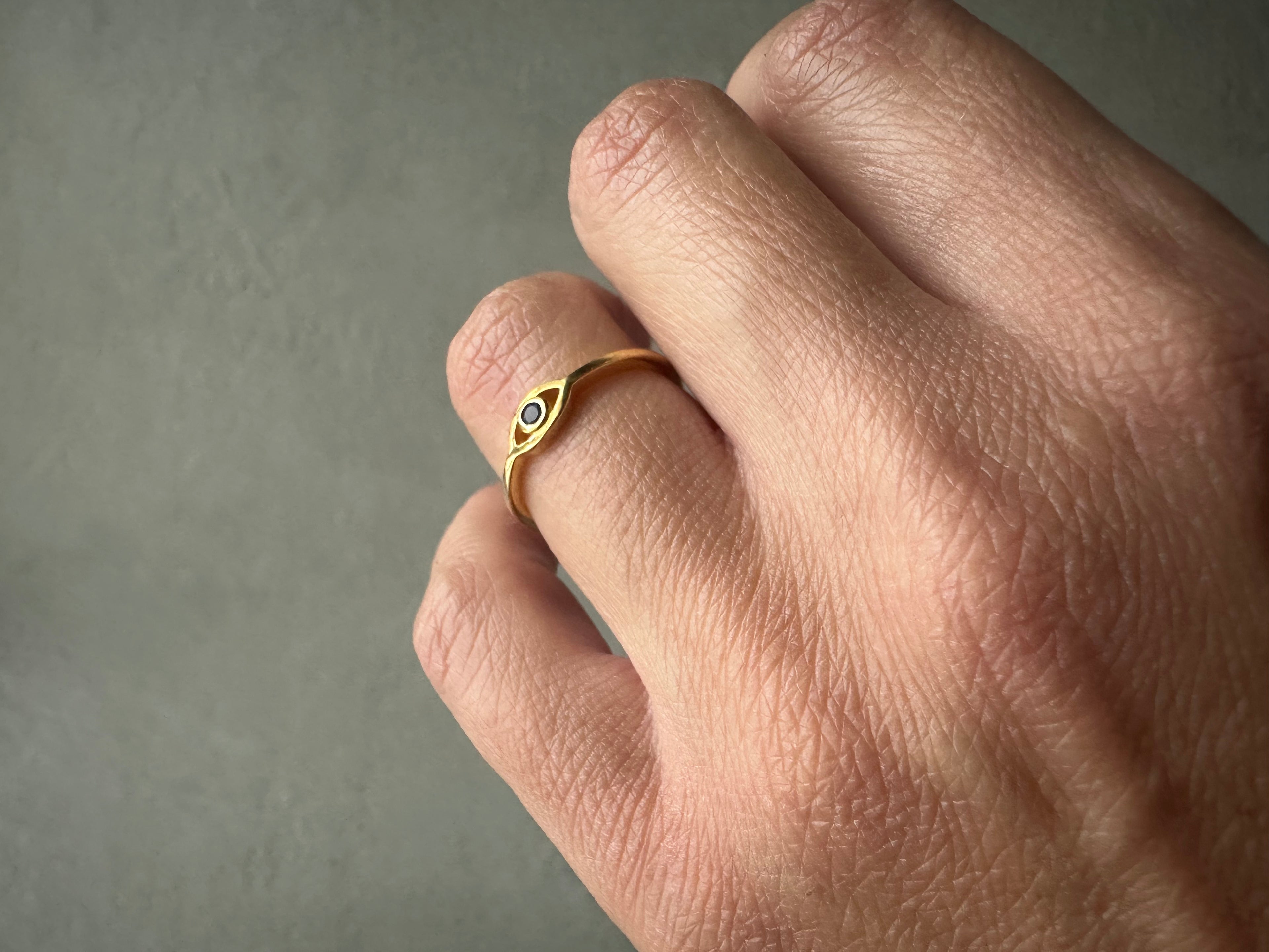 Hand wearing an eye ring