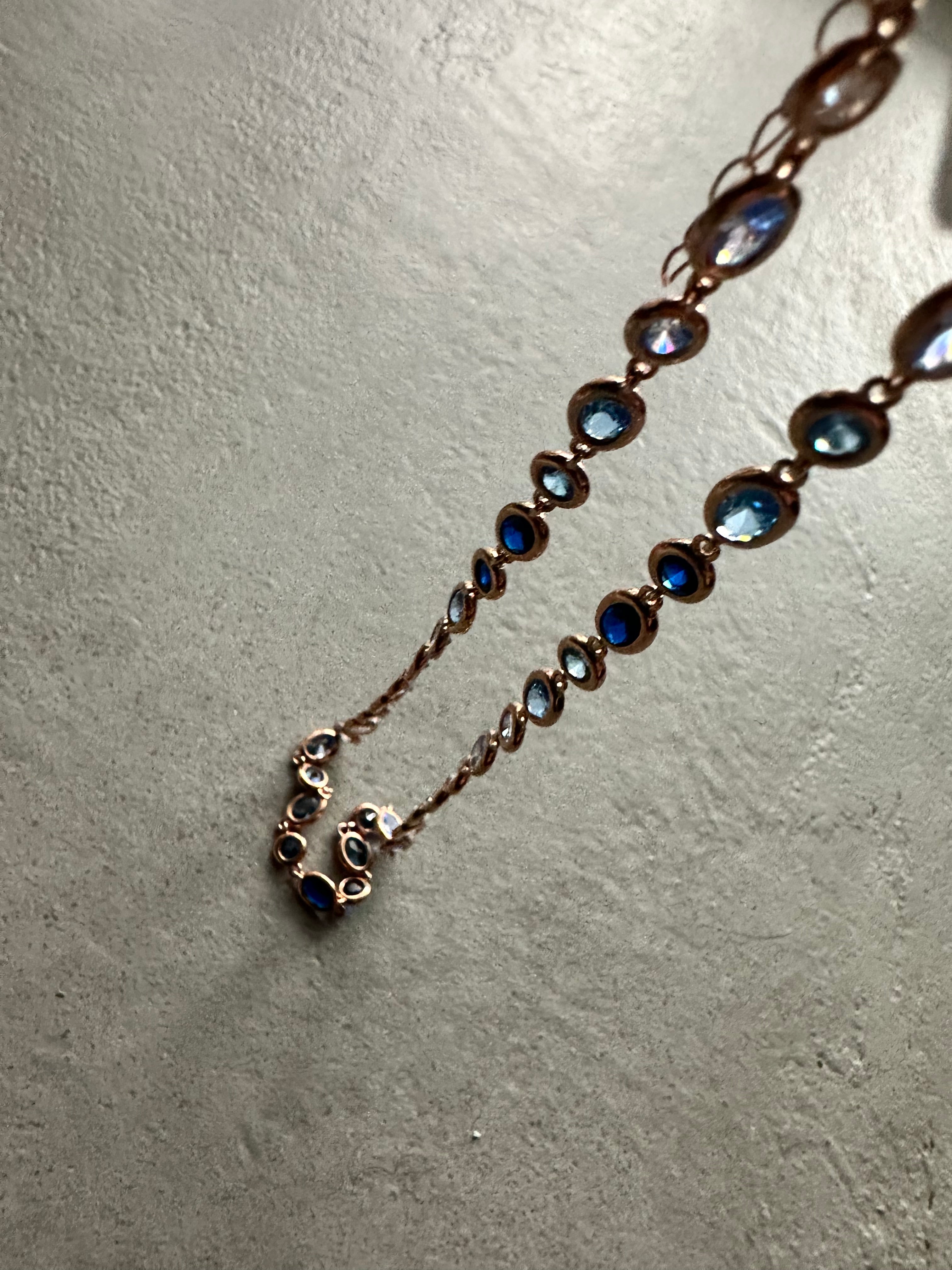 Necklace with blue stones on a textured gray surface