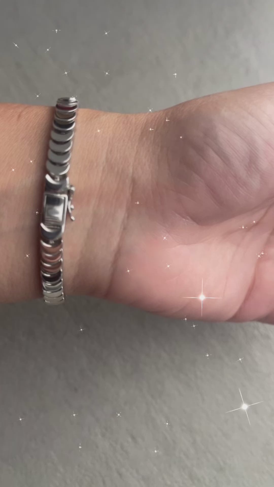 Silver bangle with a tennis bracelet clasp